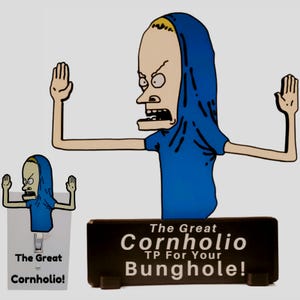 May include: A novelty item featuring a cartoon character in a blue shirt and hood, with arms outstretched. The base reads "The Great Cornholio TP For Your Bunghole!" A smaller version is on a light switch cover.