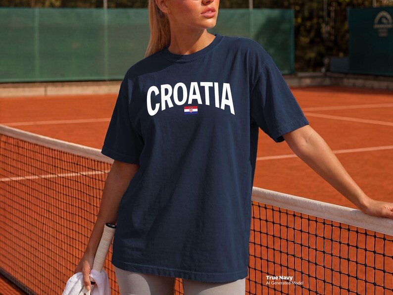 May include: Navy blue t-shirt with the word "CROATIA" in white block letters and a small Croatian flag graphic. The shirt is a crew neck style.