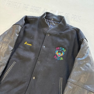 May include: A black varsity jacket with black leather sleeves and a ribbed collar. The front features the embroidered name Jason in yellow and a colorful House of Kolor logo with a scarab beetle graphic in pink, blue, and green thread.