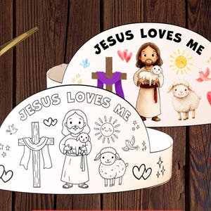 May include: Printable crown craft with the text "JESUS LOVES ME". The crown features illustrations of Jesus, a lamb, a cross, and other religious symbols. The image includes a pair of scissors and crayons.