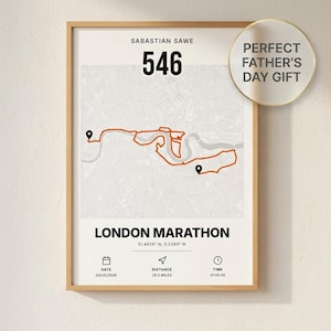 Op de afbeelding: Ingelijste print van de route van de marathon van Londen, met een kaart en een rode route. De print bevat de naam van de loper, rugnummer 546, datum, afstand van 42,16 km en tijd. De tekst "Perfect Father's Day Gift" is ook opgenomen.
