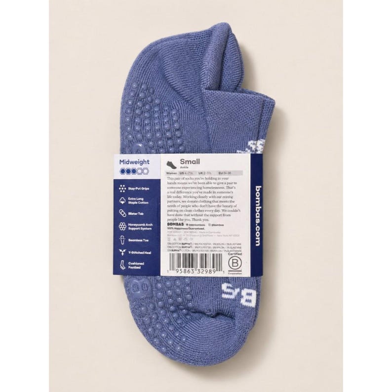 May include: A pair of blue ankle socks with a textured grip pattern on the sole. The socks are midweight and have a small size label. The packaging includes the brand name and product information.