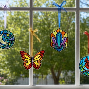 Four suncatchers hanging in a sunny window