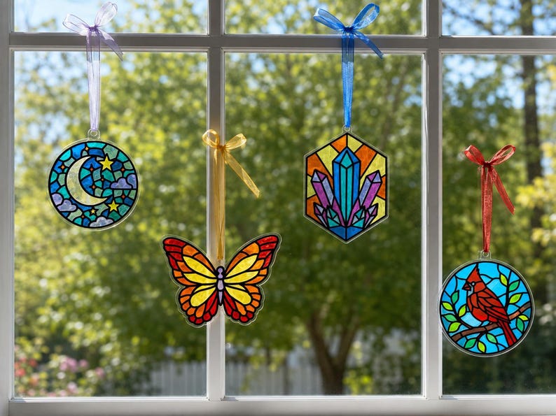 Four suncatchers hanging in a sunny window