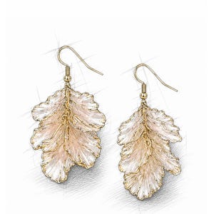 May include: A pair of gold-colored leaf-shaped earrings. The earrings have a delicate, layered design with a light pink and white color scheme. The earrings are suspended from gold-colored ear wires.