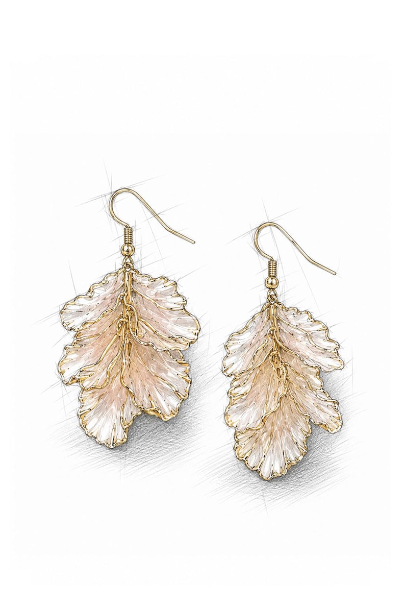 May include: A pair of gold-colored leaf-shaped earrings. The earrings have a delicate, layered design with a light pink and white color scheme. The earrings are suspended from gold-colored ear wires.