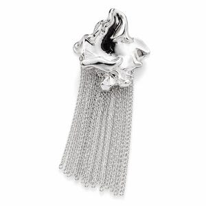 May include: A silver brooch with a fluid, abstract design and a fringe of fine chains. The polished surface reflects light, offering a contemporary and stylish accessory. The brooch is a statement piece.