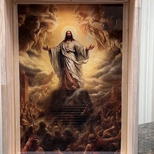 May include: A rectangular wooden tray featuring a central print of a figure with long hair and a beard, wearing a white robe with arms outstretched, standing atop a stone staircase surrounded by a crowd and clouds with a glowing halo effect.