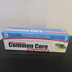 May include: A blue and white box set labeled "Common Core State Standards Kit" for Grade 3. The box includes the text "Everything you need to display the standards and 'I Can' statements for Language Arts and Math!"