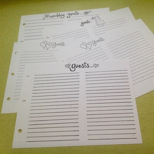 May include: White lined paper sheets with the word "guests" written in black ink, along with decorative hearts and floral designs. The sheets are for wedding guest information.