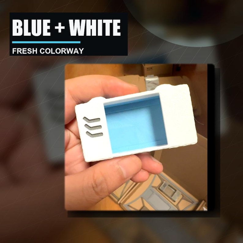May include: A rectangular white plastic object with a light blue interior cavity and three small grey chevron-shaped indentations on the front face. The text "BLUE + WHITE" and "FRESH COLORWAY" is displayed in a black box above the object.