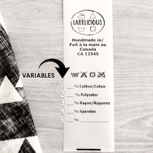 May include: A white fabric label with black text and symbols. The label reads "LABELICIOUS" and "Handmade in/ Fait à la main au Canada CA 12345". Below the text are symbols for washing instructions. The label also includes a list of fabric percentages: Cotton/Coton, Polyester, Rayon/Rayonne, Spandex.