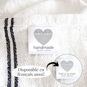 May include: White fabric with black stripes and a white label with a black heart design and the text "handmade with love". The label also has a French translation: "Fait à la main avec amour".