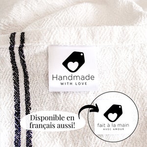 May include: White fabric with black stripes and a white tag that says "Handmade with Love" and features a black tag with a white heart. The tag also says "fait à la main avec amour" in French.