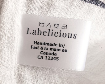 May include: White label with black text that reads "Labelicious" Handmade in/ Fait à la main au Canada CA 12345. The label also includes four care instructions symbols: a washing machine, a triangle, a circle, and an iron.