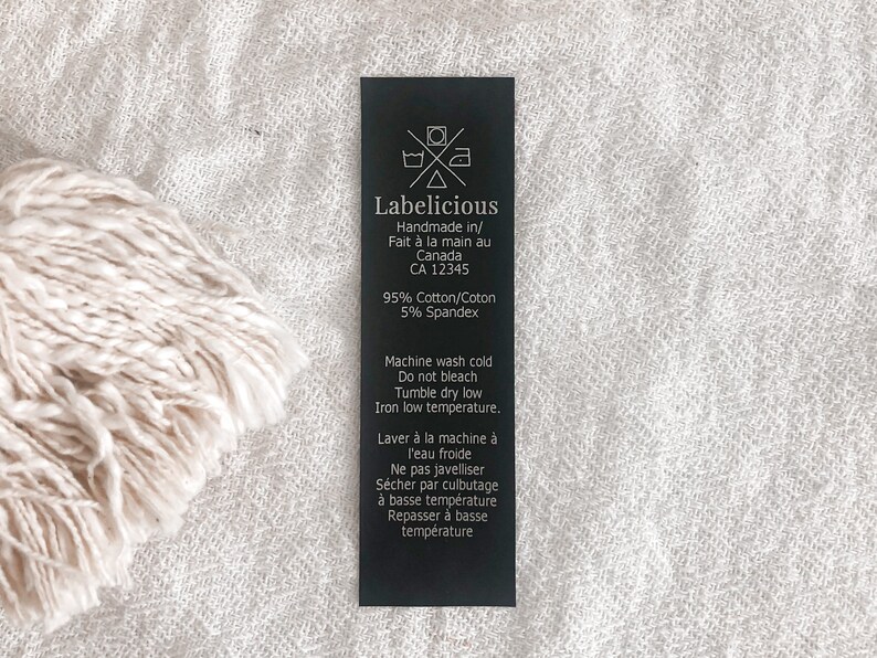 May include: Black and white care label with the text "Labelicious" and instructions for washing and caring for a garment. The label states that the garment is handmade in Canada and is made of 95% cotton and 5% spandex.