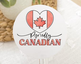 May include: White round sticker with a red heart featuring a stylized Canadian flag and the text "Proudly CANADIAN" in black.