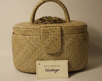 Phyllis, 1960s-70s "B.J. Imports" staw purse with beige burlap flower, magnetic clasp