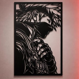 Könnte beinhalten: Ein rechteckiges Wandkunstobjekt aus schwarzem Metall mit einer detaillierten Scherenschnitt-Silhouette einer Figur mit stacheligen Haaren, einem Stirnband und einer Gesichtsmaske. Das Design zeigt das Profil der Figur mit klaren Linien.