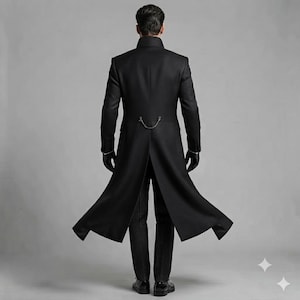 May include: A long black coat with a high collar and long sleeves, featuring a silver chain detail across the back waist. The coat is worn over dark pinstriped trousers and paired with black gloves, shown from a rear-facing perspective.