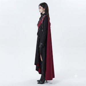 Side view of women's Vampire Military Coat worn by model, highlighting structured shoulders, fitted waist and long burgundy cape