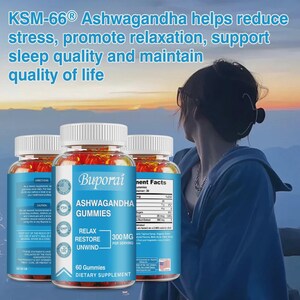 May include: Three bottles of Buporai Ashwagandha Gummies, a dietary supplement, are displayed. The bottles have white lids and blue labels with text that reads "RELAX RESTORE UNWIND" and "300 MG per serving". The background features a person looking at a sunset.