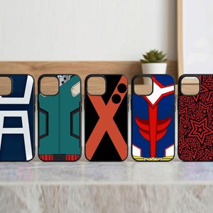 May include: Five phone cases with black borders. Designs include a white and blue symbol, a green and red costume, an orange X on black, a red and blue superhero design, and a red star pattern.
