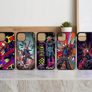 May include: Five black phone cases with colorful Spider-Punk designs. Each case features a different illustration of the character in dynamic poses, with vibrant backgrounds of red, blue, purple, and yellow. The text "SPIDER-PUNK" is visible on some cases.