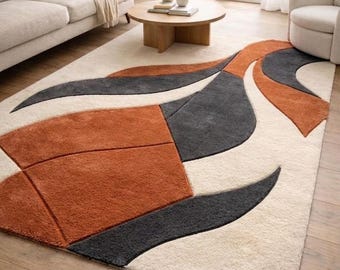 Modern abstract handgetuft vloerkleed, terracotta en houtskool woonkamertapijt, vloerkleed met organische vorm, zacht vloerdecor met textuur.