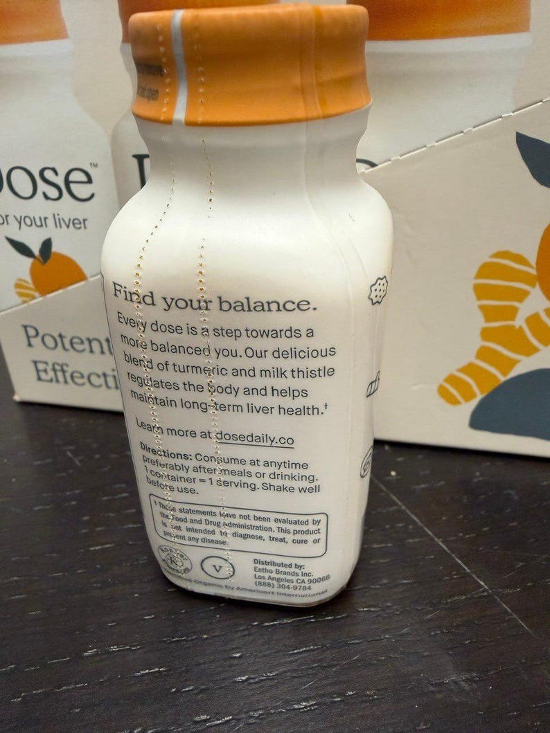 May include: White bottle with an orange cap. The bottle has text that reads "Find your balance" and "Every dose is a step towards a more balanced you." The product is for liver health and contains turmeric and milk thistle.