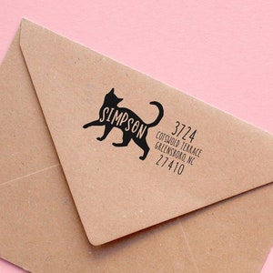 May include: A brown envelope with a black cat silhouette and the text "SIMPSON" on a pink background. The address is 3724 Cotswold Terrace, Greensboro, NC 27410.