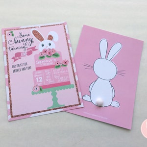 May include: Two pink birthday party invitations. One features a bunny cake design with the text "Some bunny is turning ONE." The other shows a white bunny silhouette with a fluffy tail. Both have a pink and white striped border.