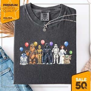 May include: Dark gray Comfort Colors t-shirt featuring a Star Wars character design with balloons. The design includes R2-D2, Chewbacca, C-3PO, Darth Vader, a Stormtrooper, Princess Leia, and Grogu. The shirt also has the text "Premium Design Quality" and "PNG File 300DPI".