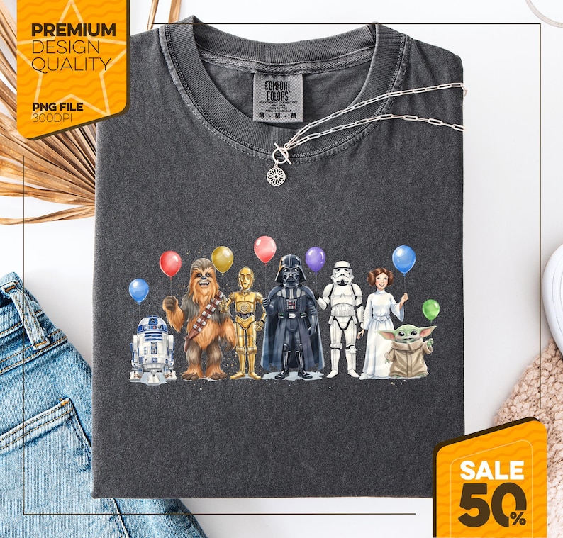 May include: Dark gray Comfort Colors t-shirt featuring a Star Wars character design with balloons. The design includes R2-D2, Chewbacca, C-3PO, Darth Vader, a Stormtrooper, Princess Leia, and Grogu. The shirt also has the text "Premium Design Quality" and "PNG File 300DPI".