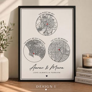 May include: A framed wall art print featuring three circular black and white city maps with red heart markers. The text reads THE NIGHT WE MET, THE NIGHT WE GOT ENGAGED, THE DAY WE MARRIED, Aarav & Meera, and LOVE ALWAYS & FOREVER with a small heart icon.