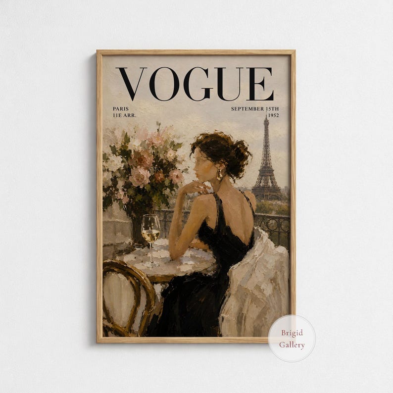 May include: A framed vintage Vogue magazine cover featuring a woman in a black dress, seated at a table with a glass of wine, overlooking the Eiffel Tower in Paris. The cover reads "VOGUE" and "September 15th 1952".