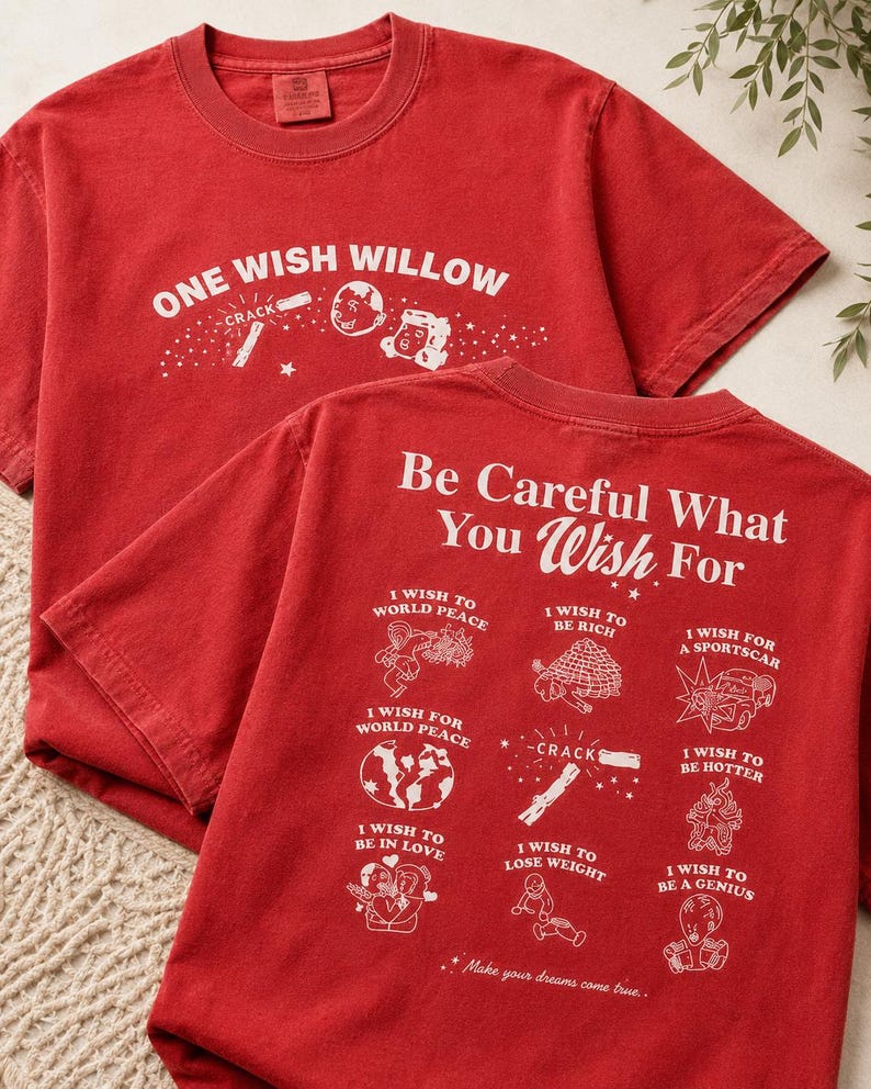 May include: Two red t-shirts with white graphic text and illustrations. The front shirt reads "ONE WISH WILLOW" with illustrations. The back shirt says "Be Careful What You Wish For" with wish-related drawings.