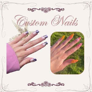 May include: Custom Nails text with two sets of press-on nails. One set features a light base with black swirling patterns. The second set displays vibrant orange and pink pointed nails, with one nail featuring a small white floral accent.