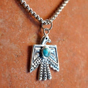 May include: A white ceramic mug with a black handle and the text "But First, Coffee" in a black, bold font. The mug is on a white surface.