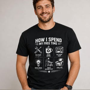 May include: A black short-sleeved t-shirt featuring white graphic text that reads HOW I SPEND MY FREE TIME. The design includes six icons with labels: FIX STUFF, DRINK COFFEE, BUY MORE GEAR, HATCH IDEAS, BUILD AWESOME STUFF, and CHILL OUT.