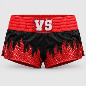 May include: Red and black athletic shorts featuring a wide, ribbed red waistband with a rectangular patch displaying the white text VS. The lower portion of the shorts is covered in red sequins with a black flame-shaped overlay pattern.