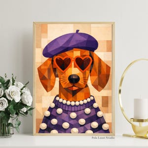 May include: A framed print featuring a geometric illustration of a dog wearing a purple beret, heart-shaped orange sunglasses, and a purple sweater with white polka dots. The background is a mosaic of tan and brown squares. The print is signed "Pola Laust Studio".