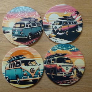 May include: Four circular coasters with illustrations of classic VW campervans, each carrying surfboards, set against sunset beach backgrounds. The coasters feature a retro design with blue, orange, and pink hues. They are made of a durable material.