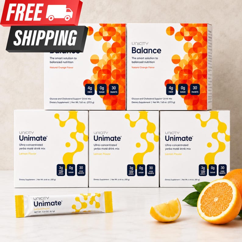 Op de afbeelding: Twee witte dozen Unicity Balance drankmix met natuurlijke sinaasappelsmaak en drie witte dozen Unicity Unimate yerba mat&eacute; drankmix met citroensmaak, met &eacute;&eacute;n individueel Unimate stick-zakje, een partje citroen en een doorgesneden sinaasappel.