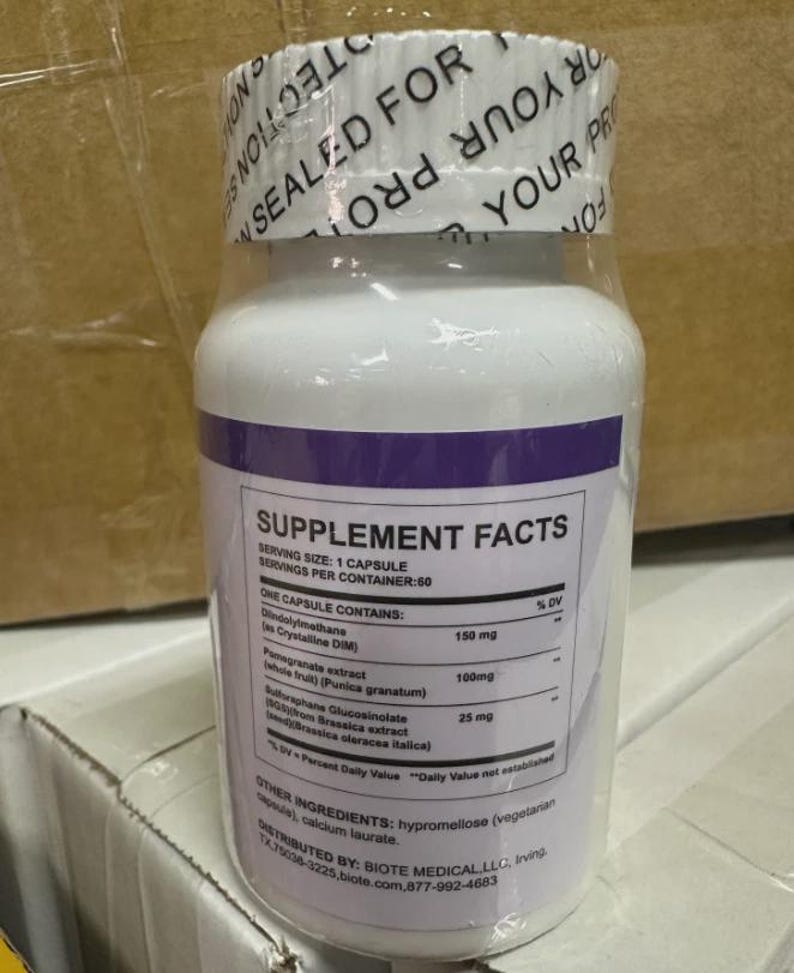 May include: White supplement bottle with a purple band and a white lid. The label includes "Supplement Facts" and ingredient information. The bottle is sealed for protection.