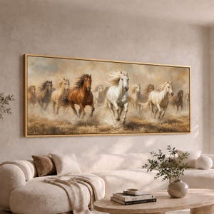 May include: A large rectangular wall art piece featuring a herd of horses galloping across a dusty field. The painting displays a group of brown, white, and tan horses with flowing manes, rendered in a painterly style with a gold-toned frame.