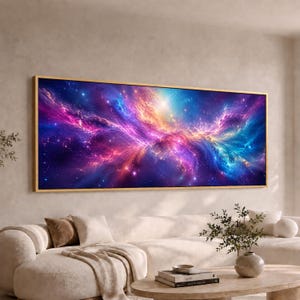May include: A rectangular wall art piece featuring a vibrant cosmic nebula with swirling clouds of purple, blue, and orange light against a dark starry background, enclosed in a thin gold frame, displayed horizontally above a white sofa.