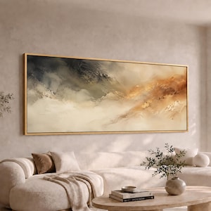 May include: A large, horizontal rectangular wall art piece featuring an abstract landscape painting with blended strokes of dark charcoal, muted sage green, warm beige, and golden amber tones, enclosed in a thin, metallic gold frame.