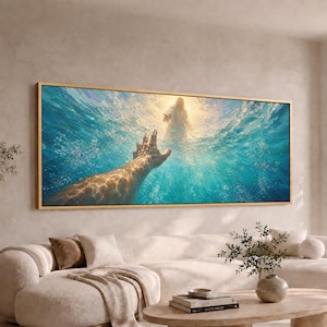 May include: A panoramic wall art print in a thin gold frame depicting a first-person perspective of a hand reaching upward through bright blue, sunlit water toward a glowing, ethereal figure standing on the surface above the water's edge.