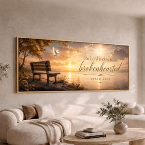 May include: A rectangular wall art print featuring a sunset landscape with a wooden bench on a rocky shore, a flying white dove, and a glowing cross in the sky. The text reads: The Lord is close to the brokenhearted Psalm 34:18 in black script.